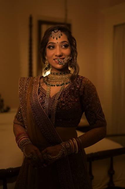 Reception bride in maroon with emerald jewellery
