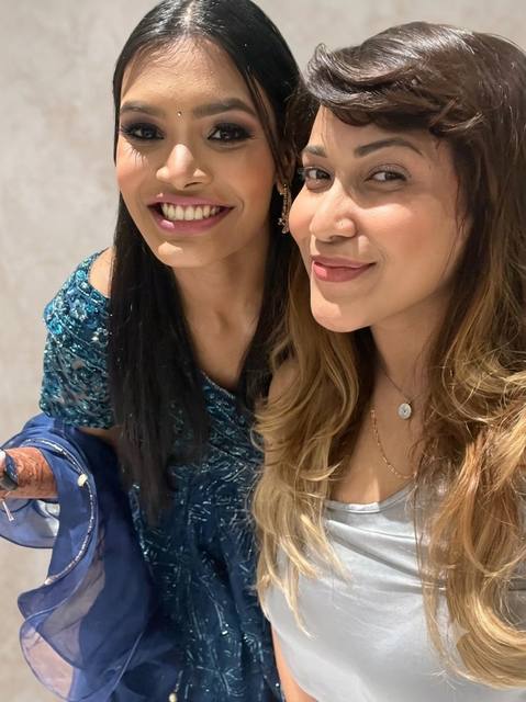 Manisha with a client in blue