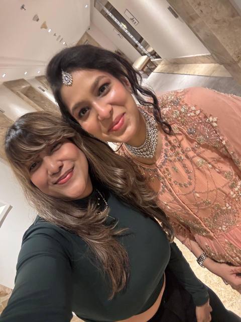 Manisha with a client in peach