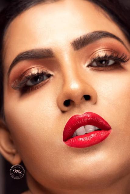 Macro beauty shot of glossy red lips and bronze eyes