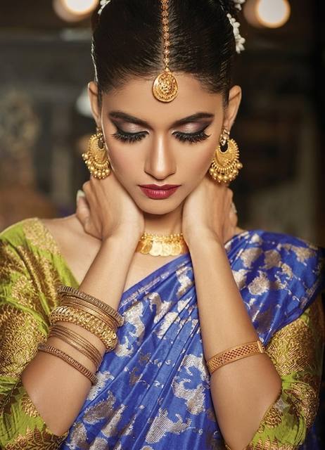 Editorial beauty in sapphire silk saree with temple gold jewellery and sleek bun