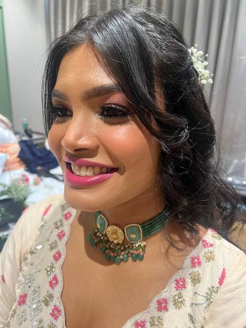 Glowing glam with cream outfit and green choker