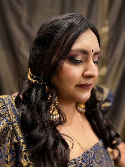 Side profile with plum smoky eyes, navy brocade and gold hair chain